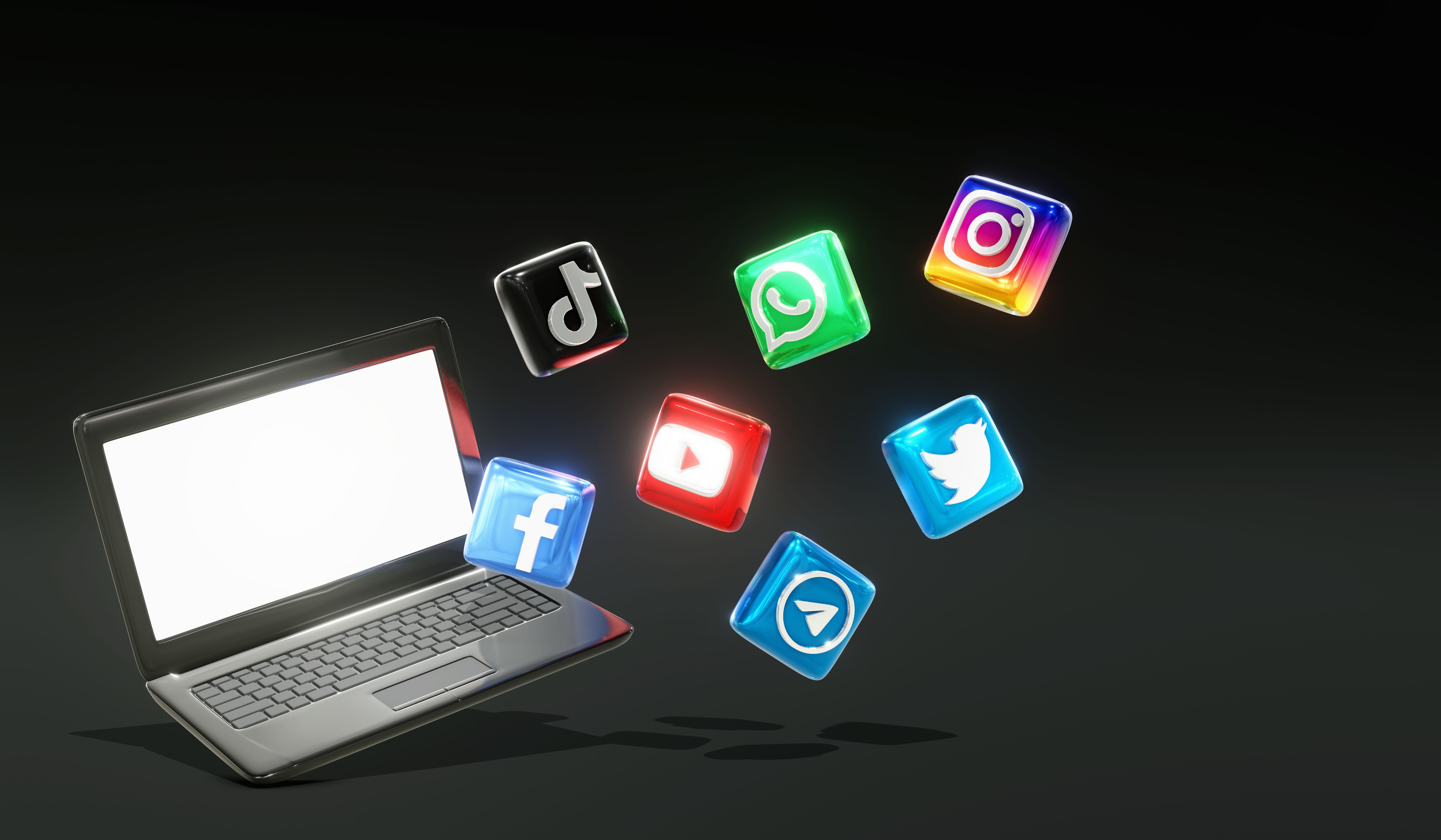 3d-glossy-social-media-logos-laptop-with-dark-background 